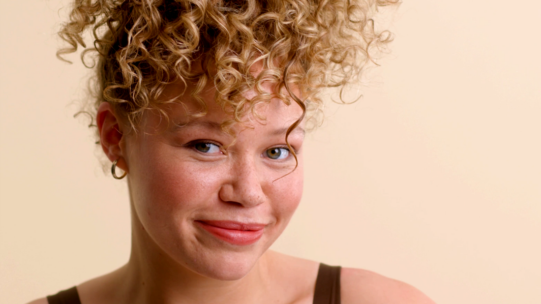 woman with curly hair in a pineapple