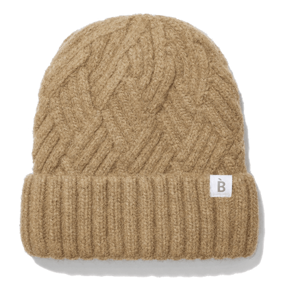 A camel cable-knit beanie hat with a ribbed cuff and a small white square label featuring a gray letter 'B', shown on a white background with a soft drop shadow.