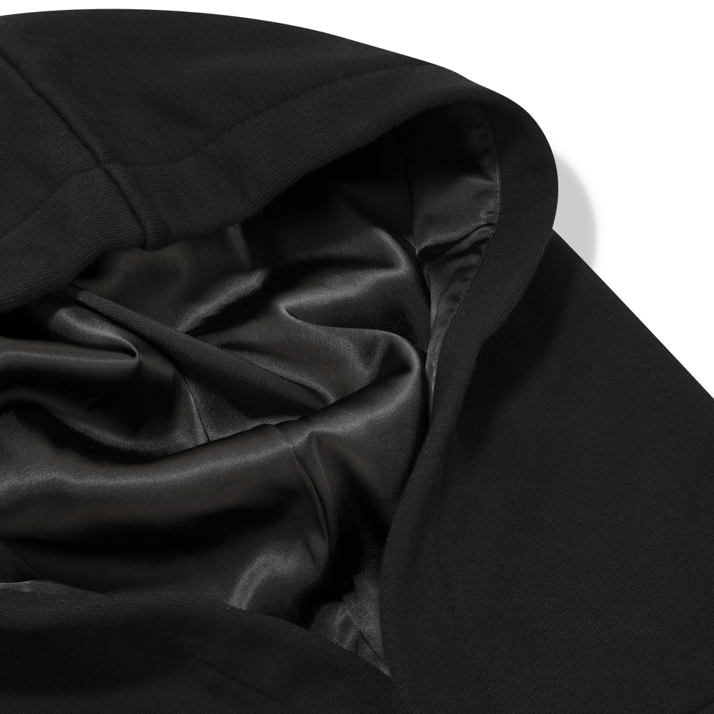 Close-up of a black silk fabric with folds on a transparent background