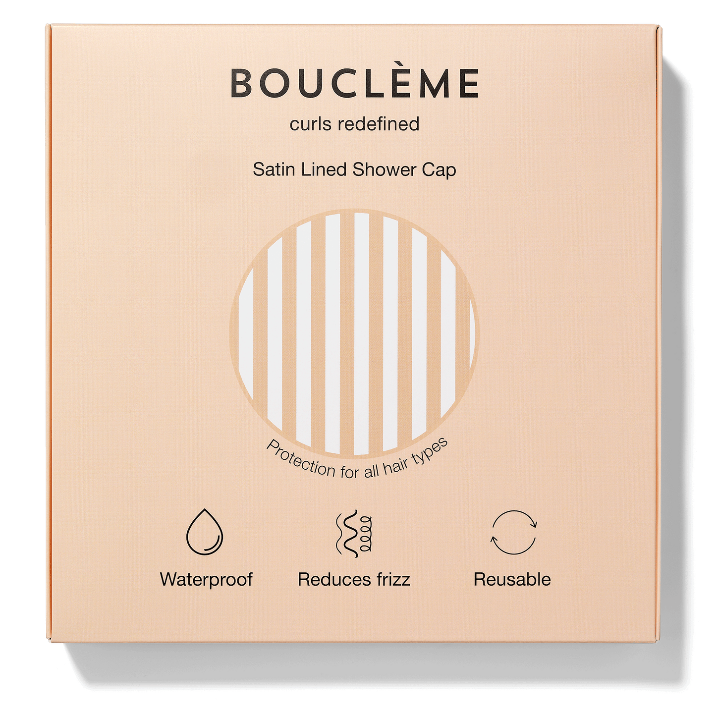 Bouclème satin-lined shower cap packaging on a beige background