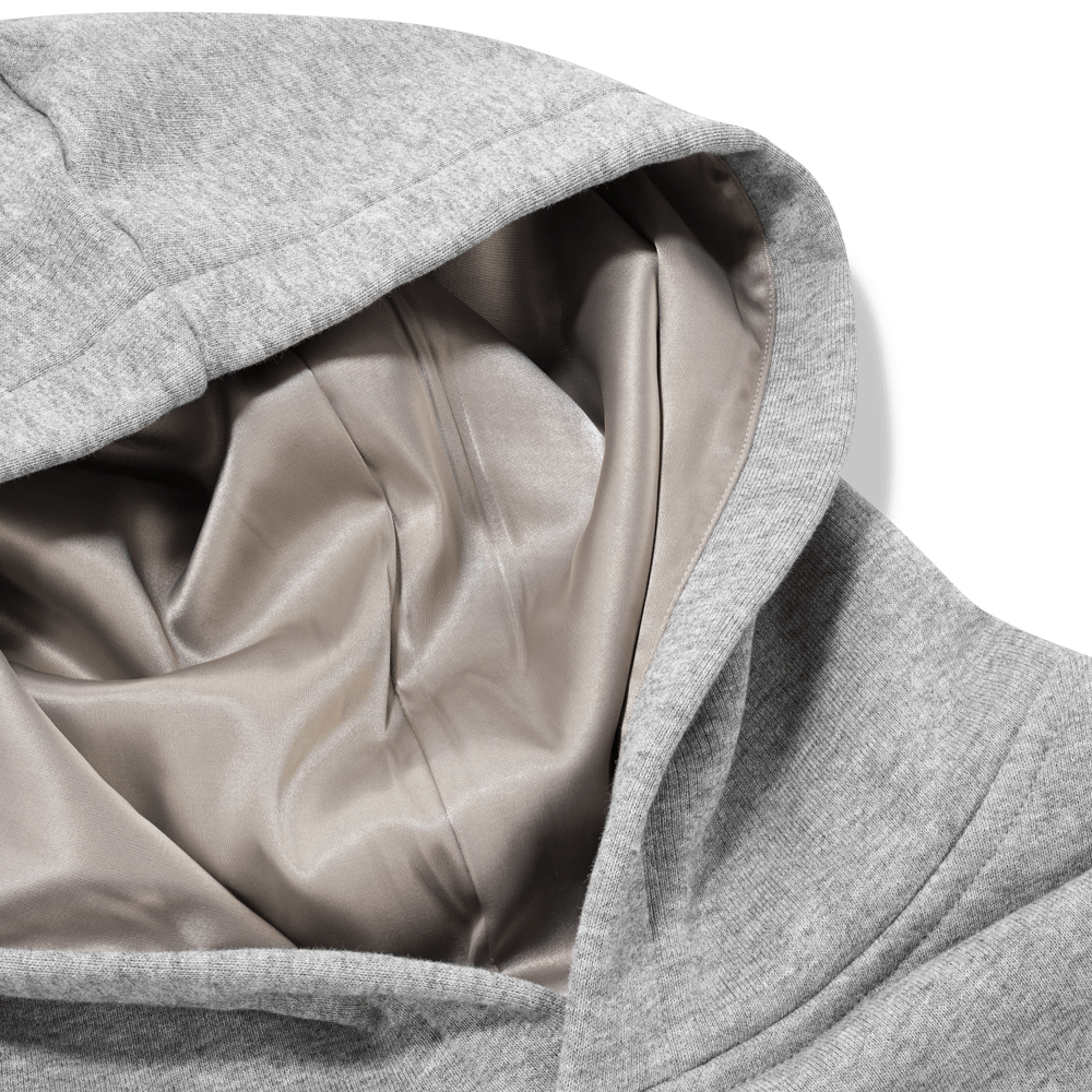 Close-up of a grey silk fabric with folds on a transparent background